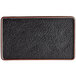 A black matte textured rectangular flat stoneware plate with a black surface.