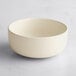 An Acopa Pangea fog white porcelain bowl on a white surface.