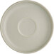 An Acopa Pangea white porcelain saucer with a circle in the middle.