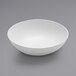 An American Metalcraft white melamine bowl on a gray surface.