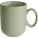 A close-up of an Acopa Pangea sage matte porcelain mug with a handle.