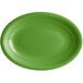 An Acopa Capri palm green oval stoneware coupe platter with a white background.