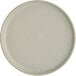 An Acopa Pangea ash matte coupe porcelain plate with a white surface.