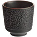 An Acopa Heika black textured stoneware tea cup.