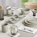 A table set with an Acopa Pangea rectangular porcelain platter, white bowls, and cups.