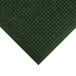 A green M+A Matting WaterHog carpet with a square pattern.