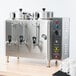 A Cecilware stainless steel automatic coffee urn machine with two taps.