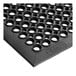 A close-up of a black rubber Choice anti-fatigue floor mat with holes in the middle.