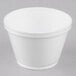 A white styrofoam food container with a lid.