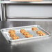 A Durable Packaging foil cake pan filled with cookies on a table.