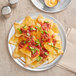 A plate of nachos with salsa and cheese served on a Choice aluminum pizza pan.