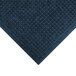 A navy WaterHog mat with a diamond pattern and fashion fabric border.