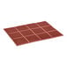 A close-up of a red rubber anti-fatigue floor mat with holes in it.