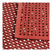 A red rubber Lavex anti-fatigue floor mat with holes.