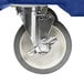 A navy blue wheel on a white metal base for a Cambro CamKiosk.