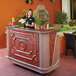 A woman using a Cambro portable bar to pour a drink.