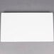 A white rectangular American Metalcraft flat melamine platter with a black border on a gray surface.