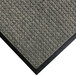 A close-up of a grey carpet mat with black rubber border.