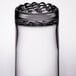 A close up of a Libbey tall highball glass with water in it.