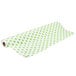 A roll of green and white polka dot paper table cover