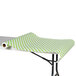 A table with a green and white polka dot paper table cover.