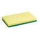 A yellow sponge with a green scouring pad on top.