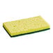 A yellow sponge with green scrubber pad on one side.