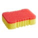 A yellow sponge with red squares on one side.