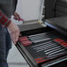 A person opening a drawer full of tools on a Valley Craft workbench.