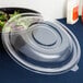A Fineline clear plastic dome lid on a bowl of salad.