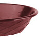 A close-up of a red oval weave basket.