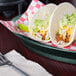 A plate of tacos in a HS Inc. jalapeno deli server on a table with a fork and napkin.