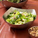 An American Metalcraft stainless steel bowl filled with salad and nuts.