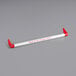 A white paper with red writing reading "Thank you for shopping" attached to a red and white Regency shopping cart handle.