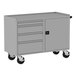 A Valley Craft silver metal workbench with 4 drawers and a door on wheels.