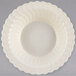 A white bowl with a scalloped edge.