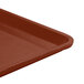 A close-up of a brown Cambro dietary tray.