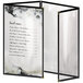 A black H. Risch, Inc. vinyl menu cover with black smooth corners and a matte finish with white interior.