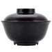 A black bowl with a red rim.
