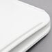 A close-up of a white tray with a handle on it.