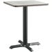 A Lancaster Table & Seating square table with a white surface and black base.