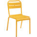 A stack of yellow Grosfillex Cannes resin outdoor sidechairs.