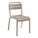 A tan plastic Grosfillex Cannes outdoor sidechair.