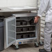 A man in a white coat opening a Beverage-Air undercounter freezer.