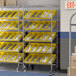 A Regency mobile chrome shelving unit with yellow bins.