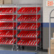A Regency chrome metal shelving unit with red slanted trays.