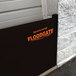 A black Quick Dam flood gate with orange text on it.