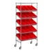 A silver metal Regency shelving unit with red slanted shelves and bins on wheels.