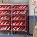 A Regency chrome shelving unit with red bins on it.