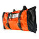 An orange and black Quick Dam duffel bag with a black strap.